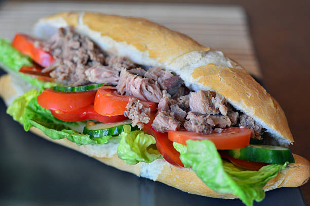 istock Tuna Baguette With Vegetables On The Brown Plate 472354940