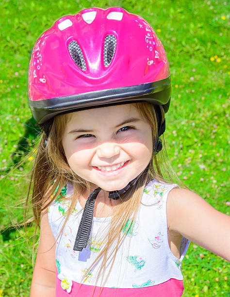 istock Girl wearing bicycle helmet 472355518