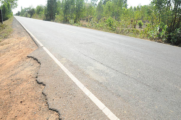 istock Cracked asphalt countryside road 472355730