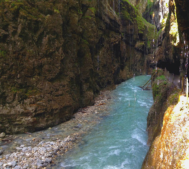 Garmisch - Partenkirchen, situated one hour south of Munich, is where you'll find the stunning Partnach Gorge (Partnachklamm). The gorge will cast its spell on you with its wild waterfalls, water rapids and tranquil water basins. Once upon a time, visitors trying to walk through the gorge risked their lives, but nowadays there are two safe paths available. A fascinating perspective view offers the iron bridge with its height of around 225 feet / 70 metres.