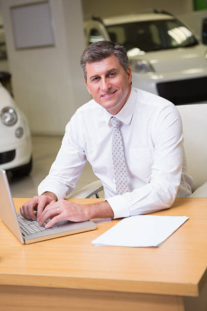 istock Cheerful businessman typing on laptop 472362424