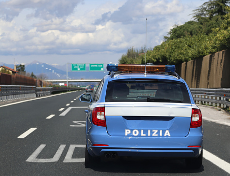 blue italian police car run fast in the italian highway