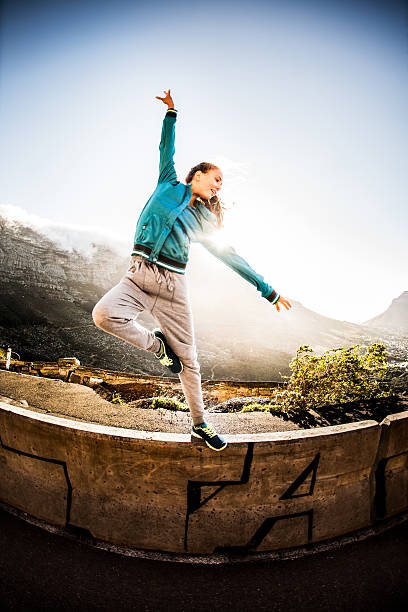 istock Graceful teen performing classical dance moves on a wall 472364366