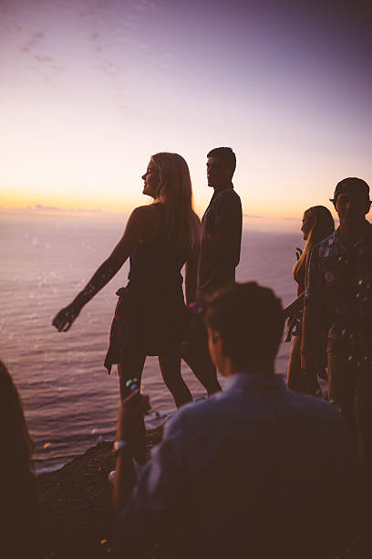 istock Teens looking at the ocean after sunset on a mountain 472366908