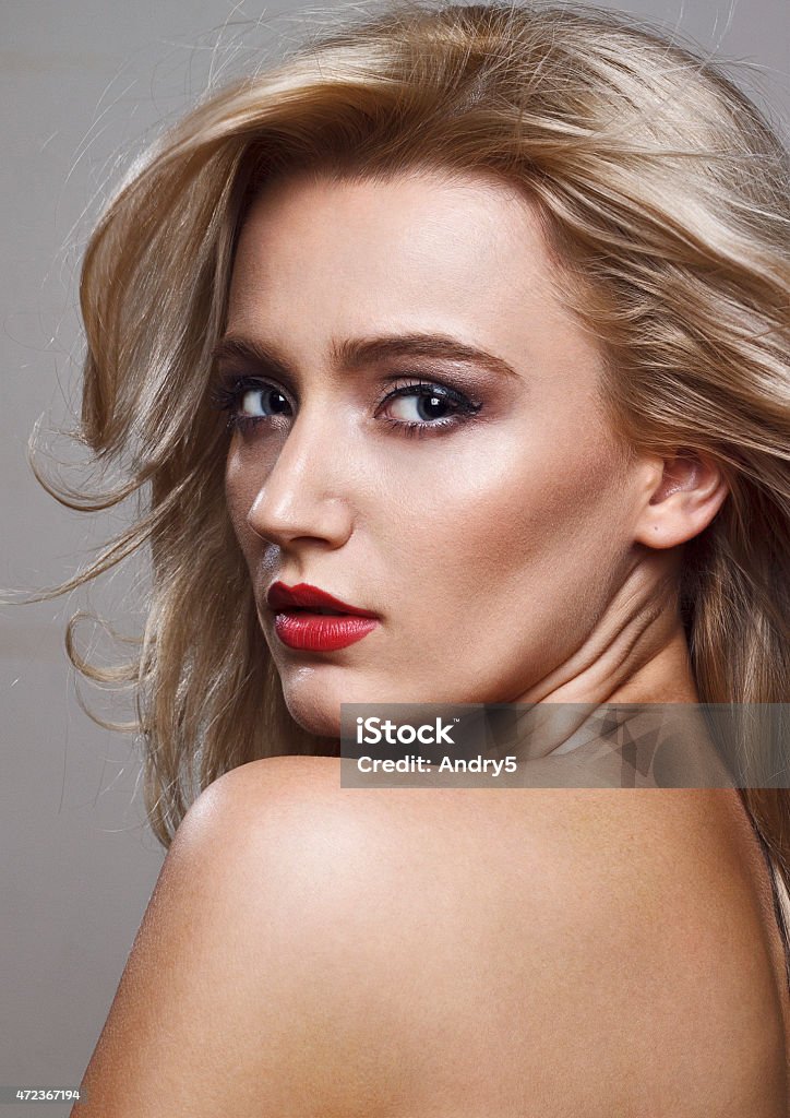 Beautiful blonde woman Close-up beauty shot of a beautiful young blonde women with the wind in the hair and sensuality in the eyes. 2015 Stock Photo