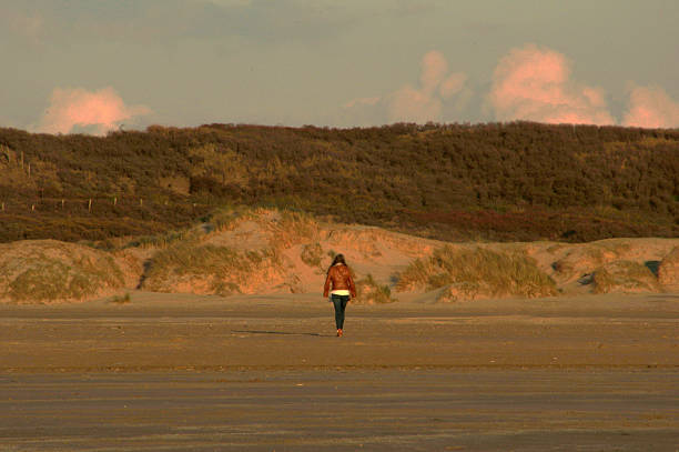 istock Women walking in the dune 472369194