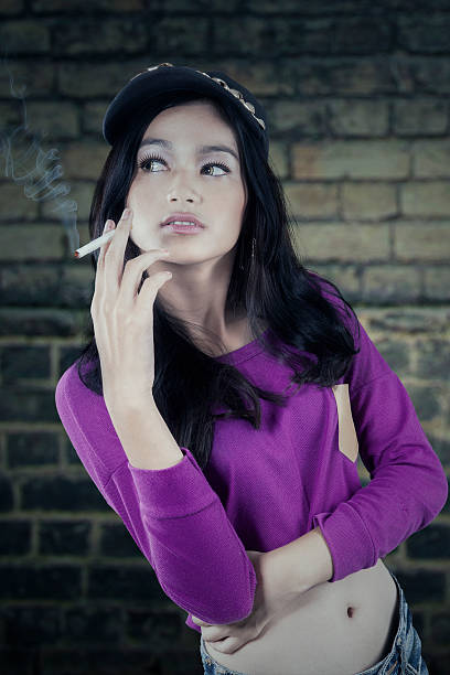 istock Casual girl smoking a cigarette 472371758