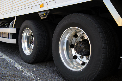 Wheel of large truck and trailers.