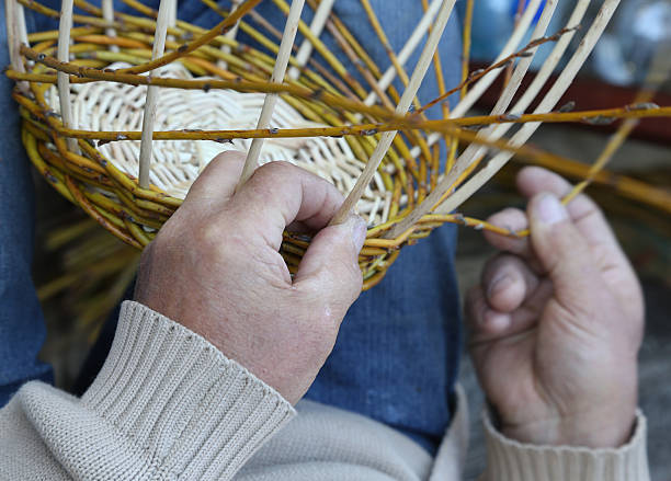 istock expert hands of craftsman creates a woven wicker basket 472374366