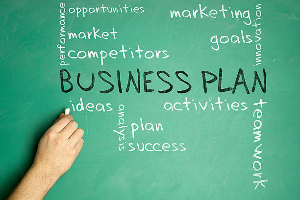 istock Men’s hand writing business plan on the blackboard, word cloud 472382340