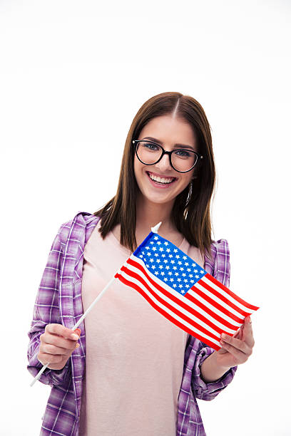 istock Smiling young girl holding US flag 472386350