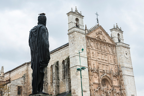 Statue of King Felipe II in San Pablo Square looking at the main facade of San Pablo Church, an Isabelline Gothic-Plateresque church built by Cardinal Juan de Torquemada between 1445 and 1468. The statue is a replica of the one in the Plaza de la Armeria in the Royal Palace of Madrid.