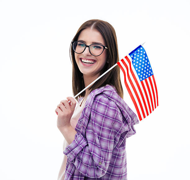 istock Happy young female student holding US flag 472386366