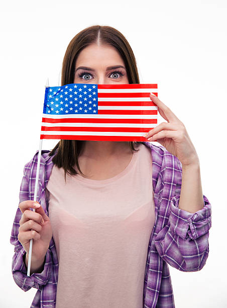 istock Young student covering her mouth with US flag 472386380