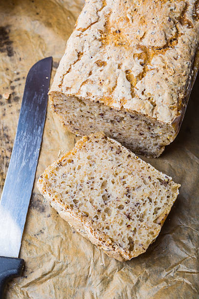istock Freshly baked homemade bread on a wooden kitchen table 472387170