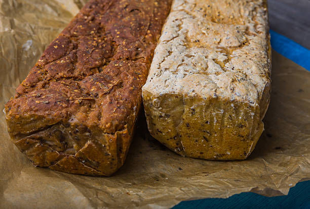 istock Freshly baked homemade bread on a wooden kitchen table 472387304