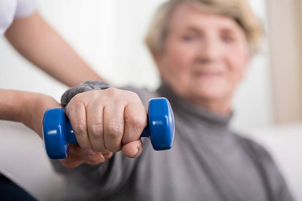 istock Elder woman training with physiotherapist 472390328