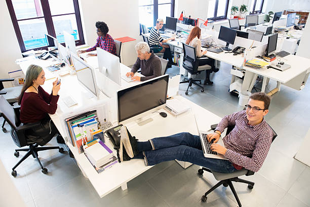 istock Confident businessman using laptop with feet up on table 472391312