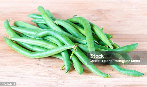 Green Beans Sheath Over Wood Cutting Board Realistic Approach Stock Photo - Download Image Now