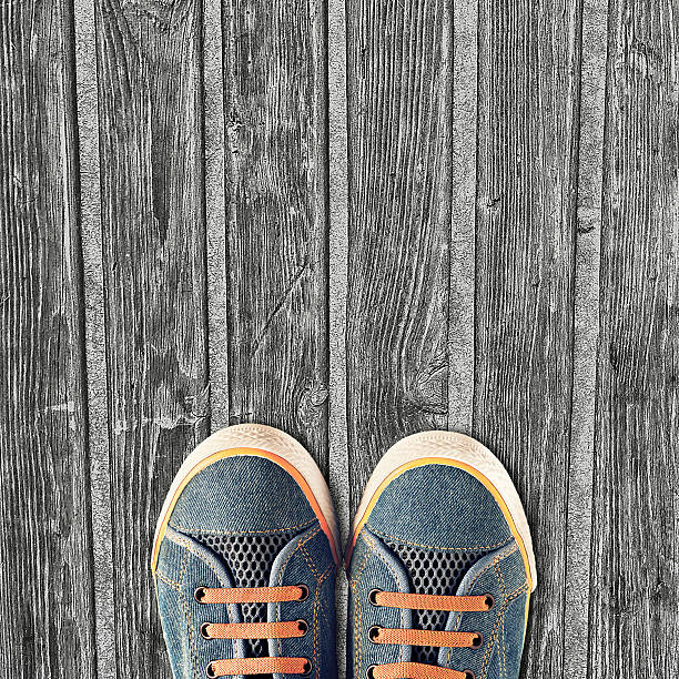 istock Hipster sneakers on a light wooden background 472393016