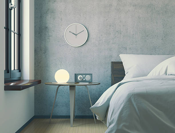 Old fashioned alarm clock on night table.