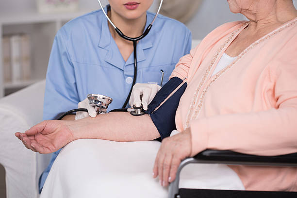 istock Disabled woman having measured pressure 472398500