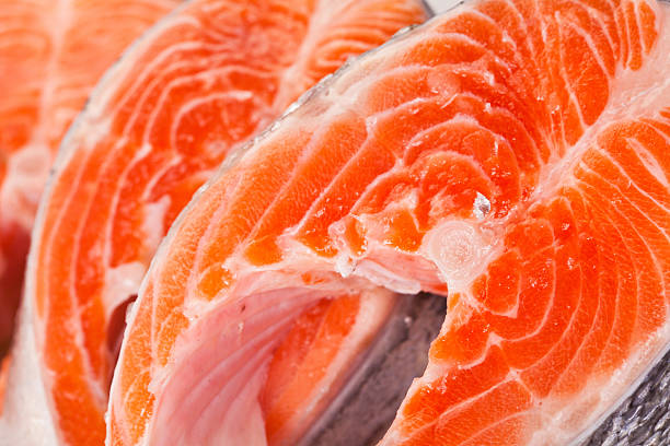 istock Raw salmon steaks are zoomed on white 472399244