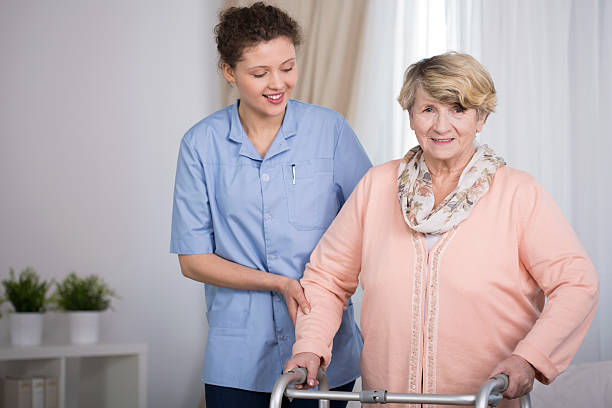 istock Senior woman and supporting nurse 472399446