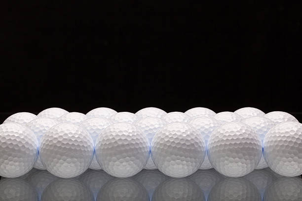 istock White golf balls on a glass desk 472401922