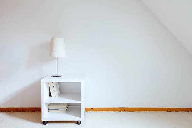 istock lamp on nightstand in white room 472402512