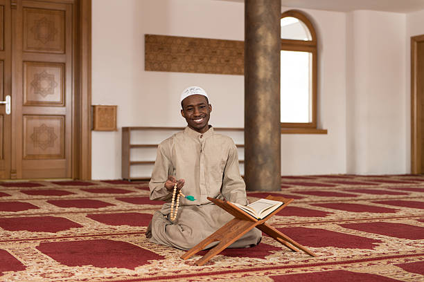 istock Muslim Man In Dishdasha Is Reading The Quran 472408900
