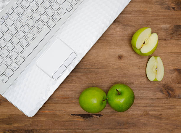 istock Several green apples and  laptop 472411494
