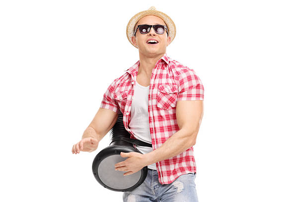istock Young joyful man playing on a doumbek and dancing 472413780