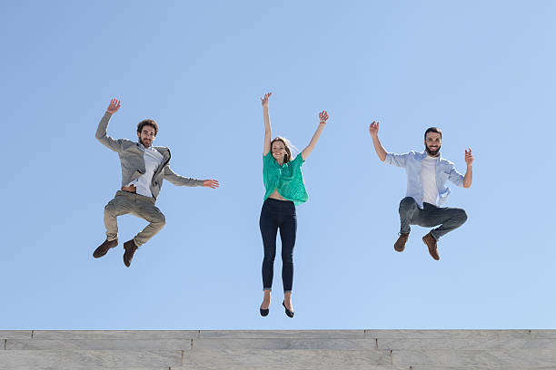 istock Three friends jump on top of a staircase 472414198