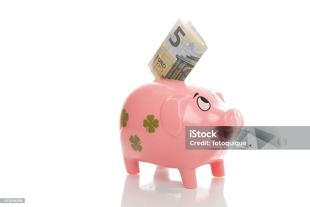 Pink piggy bank, Euros Pink piggy bank with five Euro bill 2015 Stock Photo