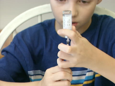 Young Boy Filling Insulin Syringe 1