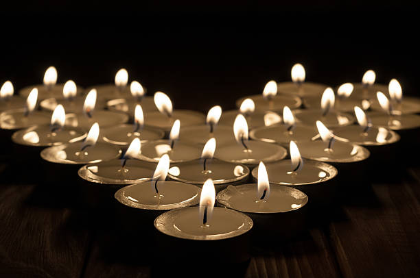 istock Candles on old wooden background 472463460