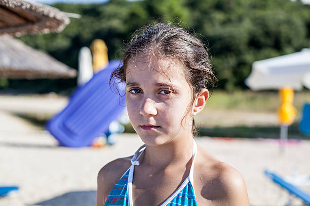 istock Portrait of sad child on the beach 472464236
