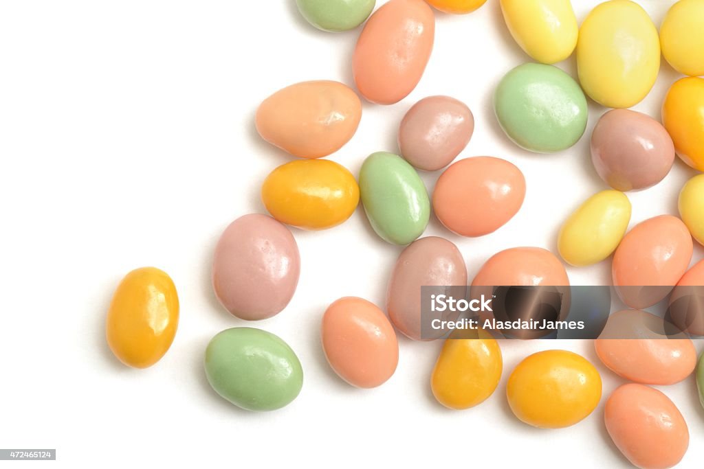 Fruit yogurt coated raisins scattered Fruit flavoured yogurt coated raisins scattered across a white background. 2015 Stock Photo