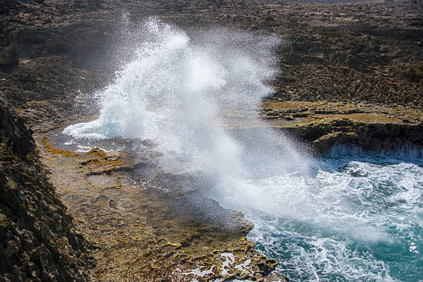 istock Splashing waves at a rough and rocky coastline 472465794