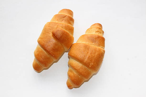 istock Two isolated butter croissants on a white background 472466594