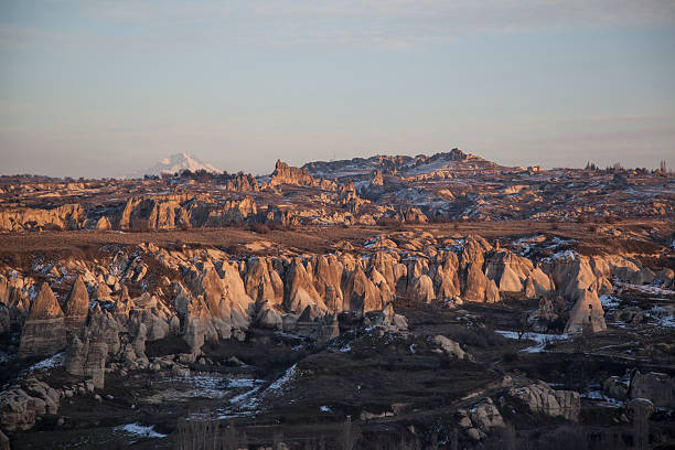 Rocky landscape in Cappadocia, Central Turky Sunset over of a rocky landscape in Turkey, Cappadocia. In the Background the mount Erciyes. Goreme stock pictures, royalty-free photos & images