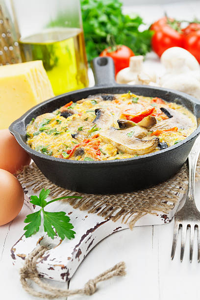 istock Omelet with mushrooms and tomatoes. Frittata 472469428
