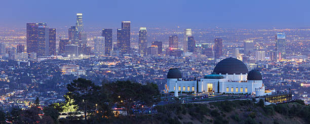 Los Angeles Skyline + Observatory Griffith Observatory located on the slopes of Griffith Park’s Mount Hollywood has a great view of Downtown Los Angeles - one of the largest urban skylines in the country. The skyscrapers are all modern since the city did not permit any structures taller than the 27-story City Hall until 1958. griffith park observatory stock pictures, royalty-free photos & images