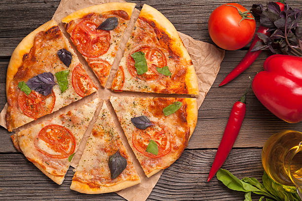 istock Sliced traditional italian pizza margherita with tomatoes, olive 472471444