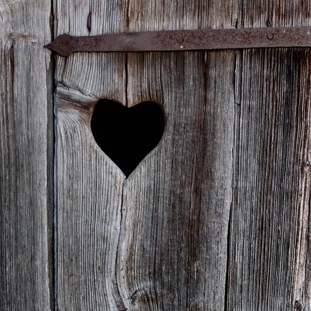 A cut-out heart in a wooden toilet door, a typical bavarian sign on a composting outhouse, a so-called "Häusl". Picture taken near Amerang, Bavaria.  