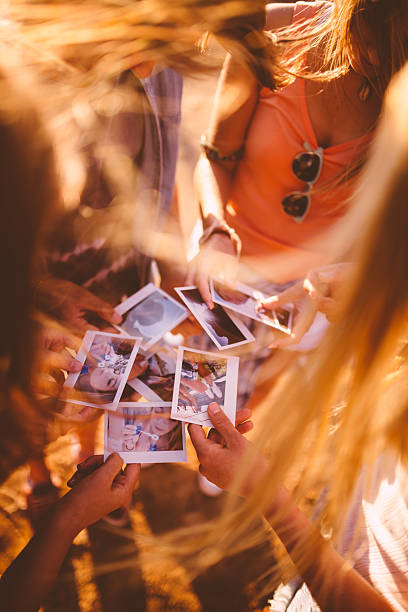 istock Teens sharing instant photos of their summer vavcation 472475822