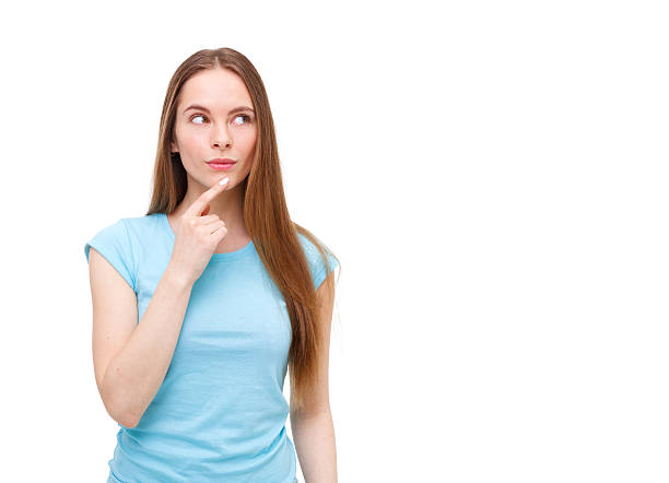 istock Beautiful thoughtful woman looking up - isolated on white. 472475844
