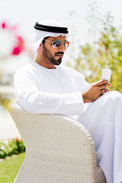 istock Relaxing and reading in a Dubai garden. 472475876