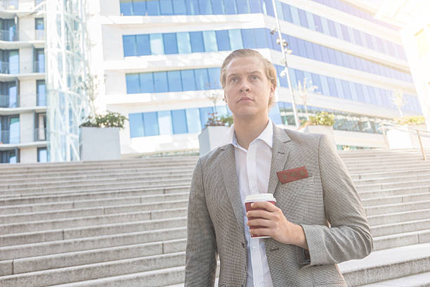 istock Fashioned young man in Oslo holding a cup of coffee 472476546